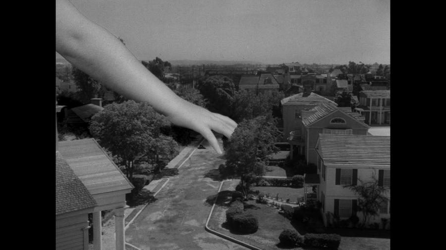 Alien girl's hand in toy city